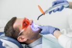 laser-zahnaufhellung-bleaching - mann am Behandlungsstuhl mit si