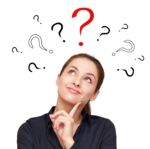 Thinking smiling woman with questions mark above head looking up